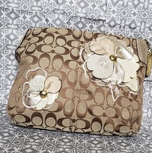Coach brown logo handbag with flower decor.